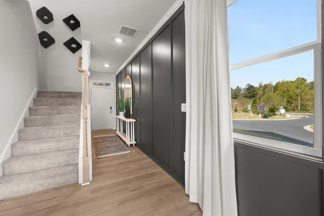 a view of a hallway with wooden floor windows and entryway