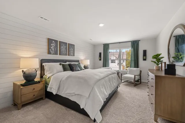 a bedroom with bed and large window