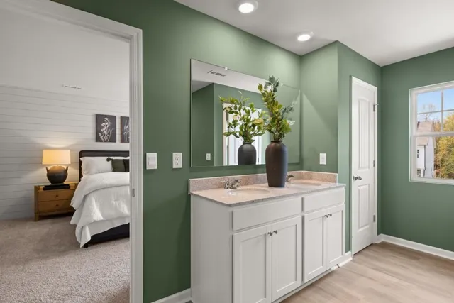 a bedroom with a bed and a large mirror