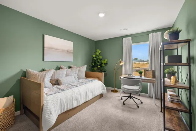 a bed room with a bed and a chair