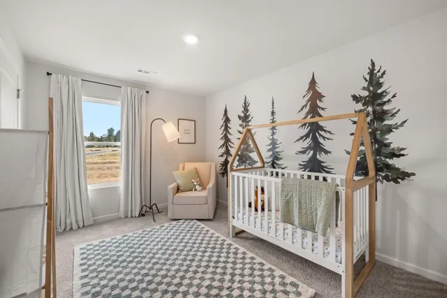 a view of a bedroom with furniture