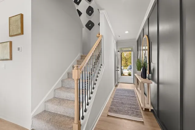 a view of a hallway with wooden floor and entryway