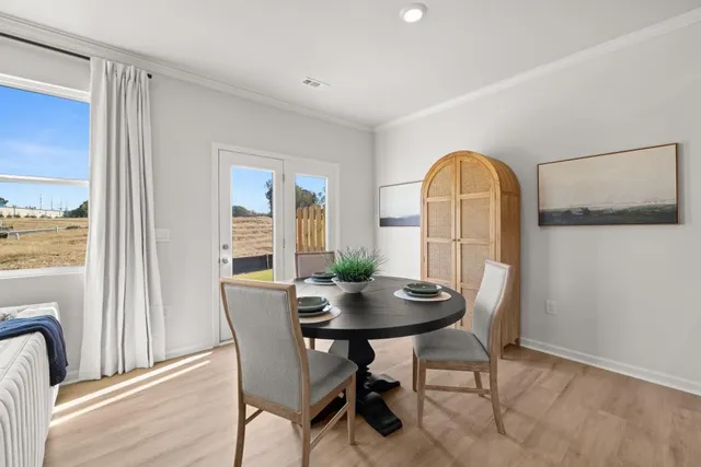 a view of a dining room with furniture and wooden floor