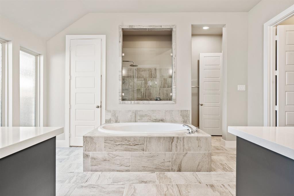1314 Buttermere Street Forney, TX 75126 - Photo 12 of 32 a spacious bathroom with a bathtub and a sink
