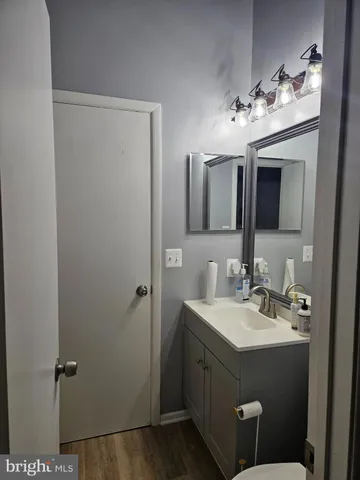 a bathroom with a sink vanity and mirror