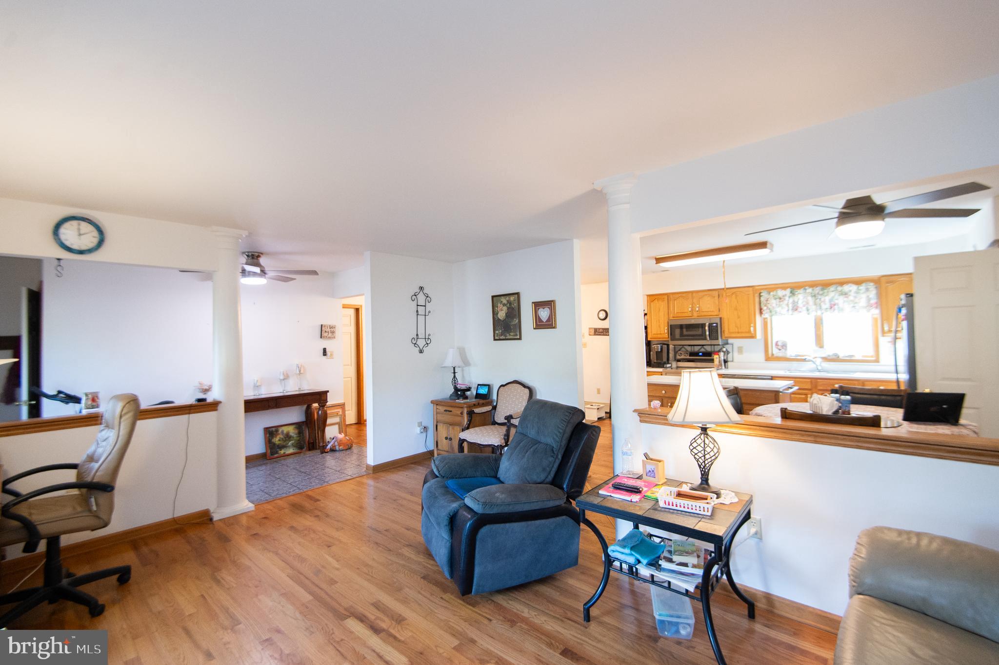 6010 Todds Point Road Cambridge, MD 21613 - Photo 11 of 52 a living room with furniture and large windows