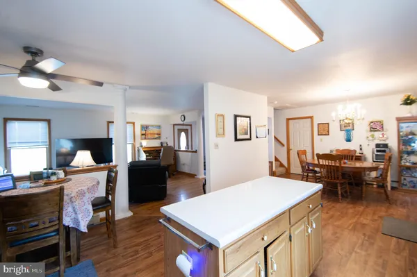 a living room with furniture a dining table and wooden floor