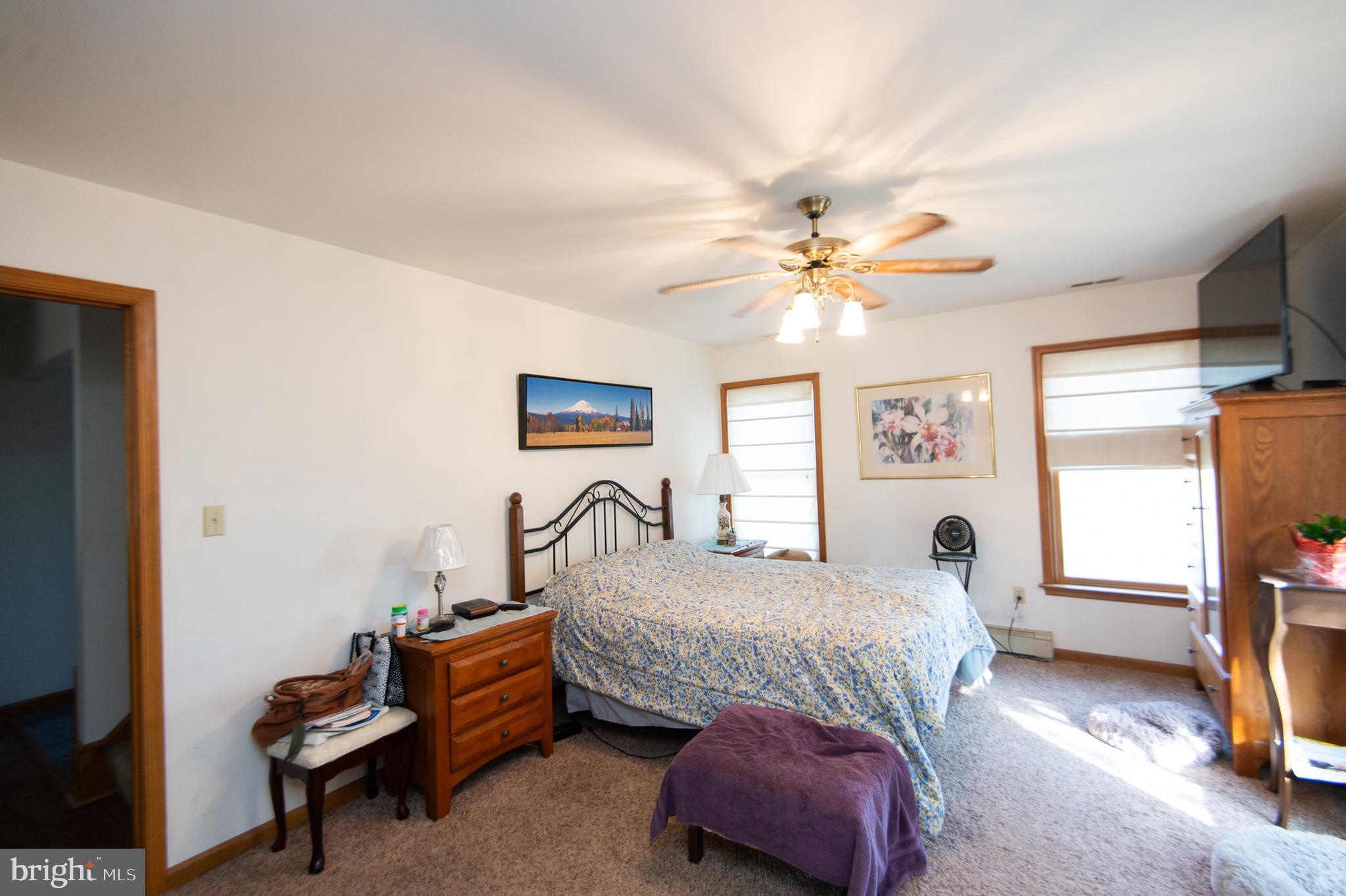 6010 Todds Point Road Cambridge, MD 21613 - Photo 25 of 52 a bedroom with a bed and a chandelier