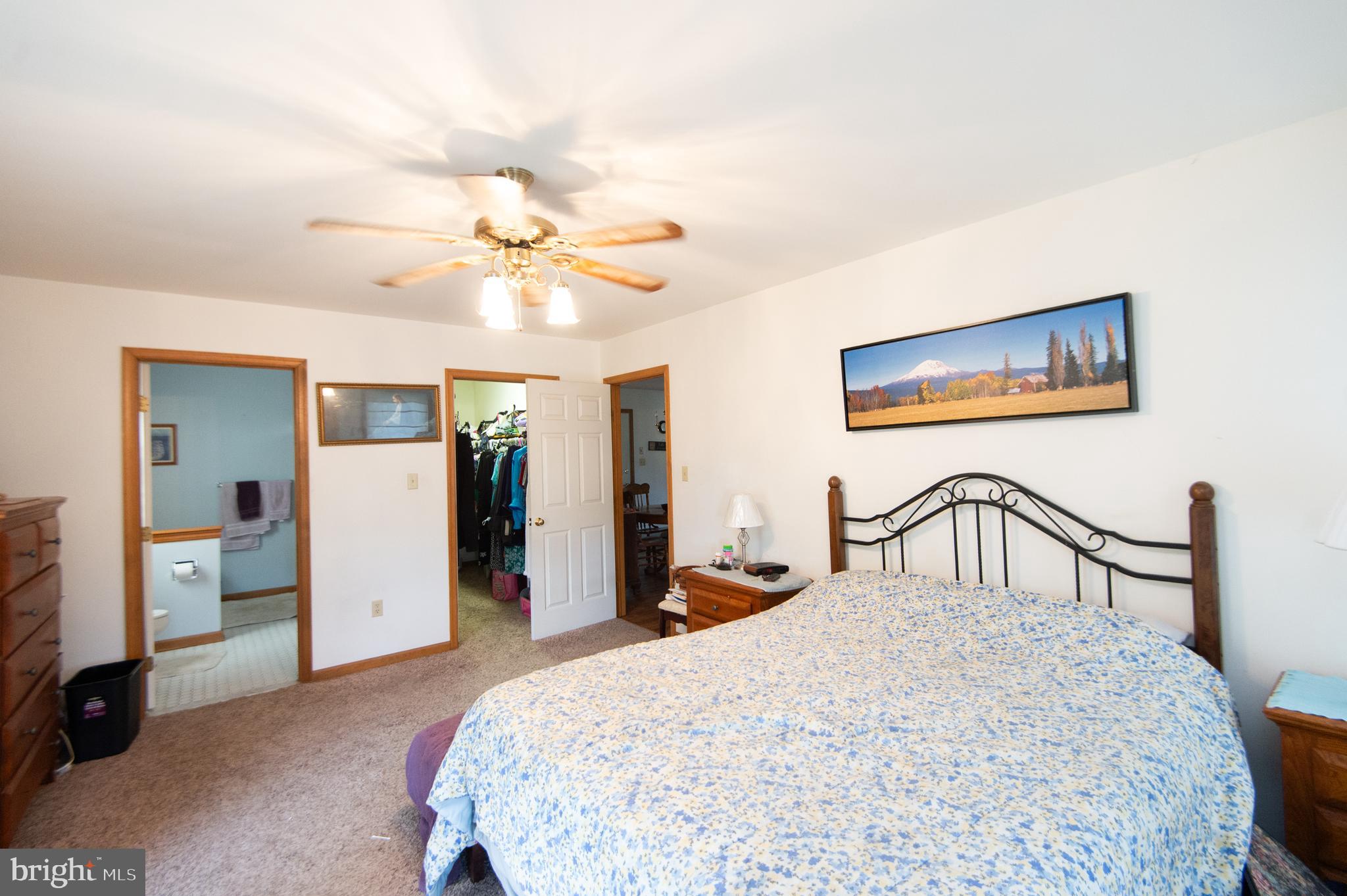 6010 Todds Point Road Cambridge, MD 21613 - Photo 26 of 52 a bedroom with a bed and a chandelier