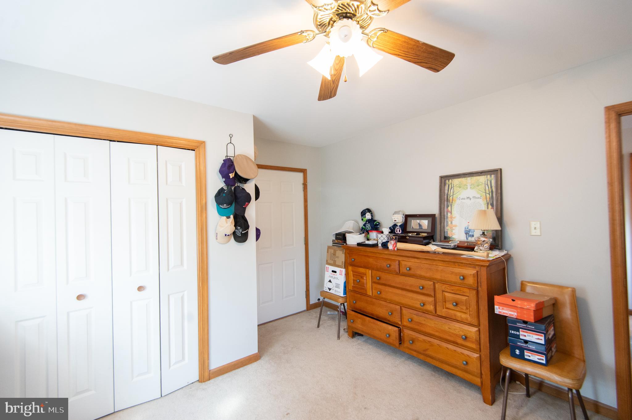 6010 Todds Point Road Cambridge, MD 21613 - Photo 33 of 52 a bed room with a bed and a chandelier