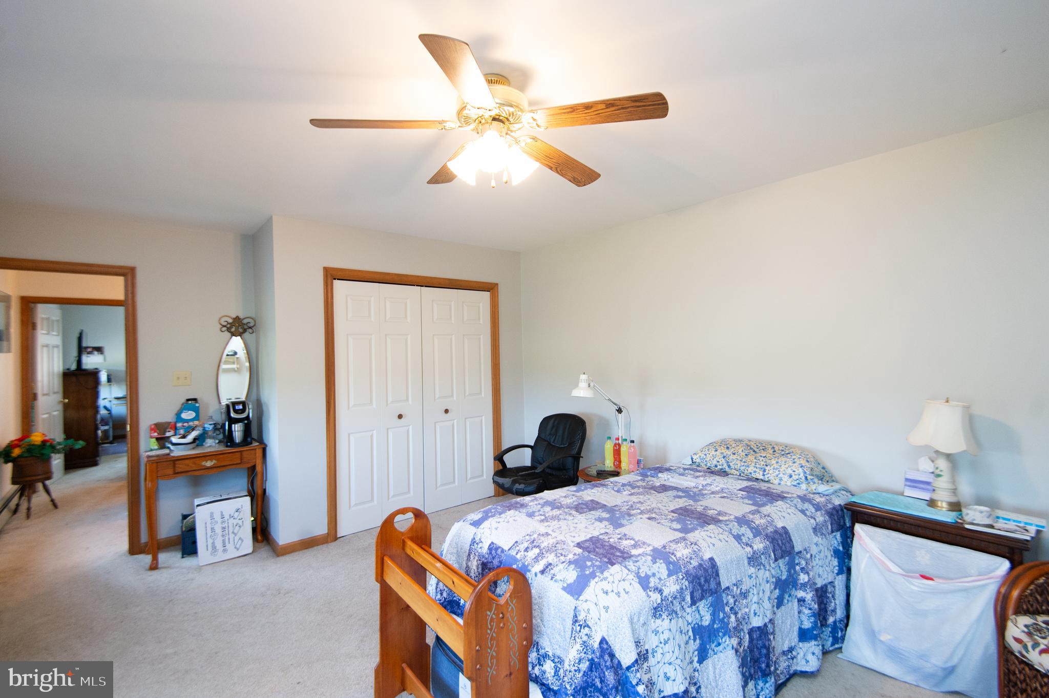 6010 Todds Point Road Cambridge, MD 21613 - Photo 39 of 52 a bedroom with a bed and a chandelier