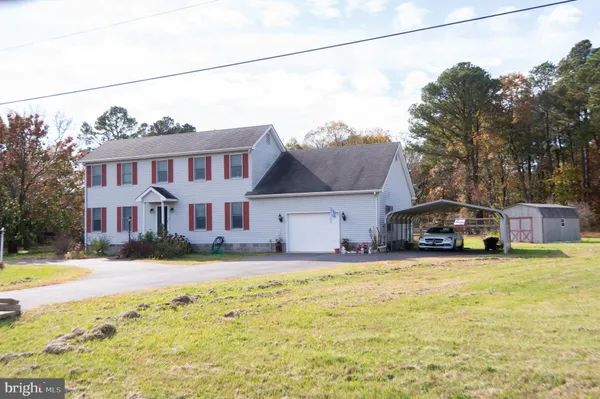 a front view of a house with swimming pool and a yard