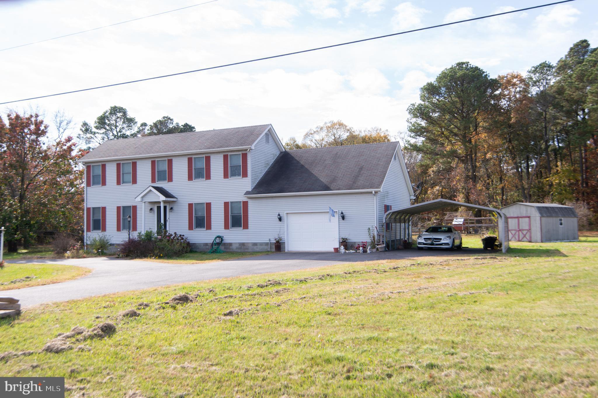 6010 Todds Point Road Cambridge, MD 21613 - Photo 5 of 52 a front view of a house with swimming pool and a yard