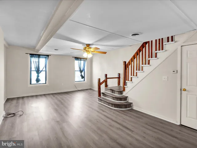 a view of a room with wooden floor