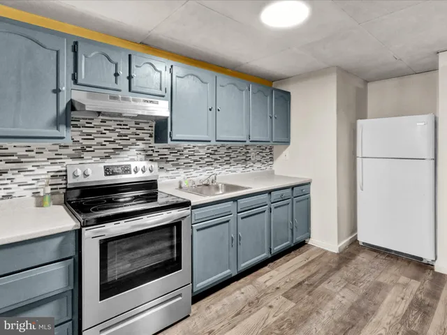 a kitchen with a sink stove and refrigerator