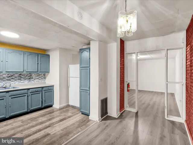 a view of a room with wooden floor