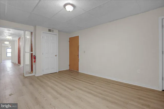 a view of an empty room with wooden floor