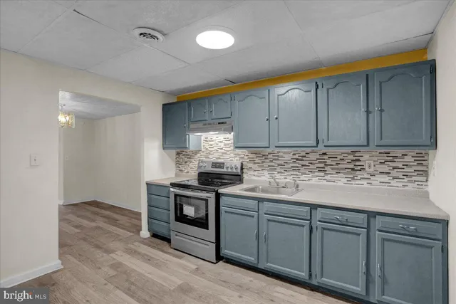 a kitchen with stainless steel appliances granite countertop a stove and a sink