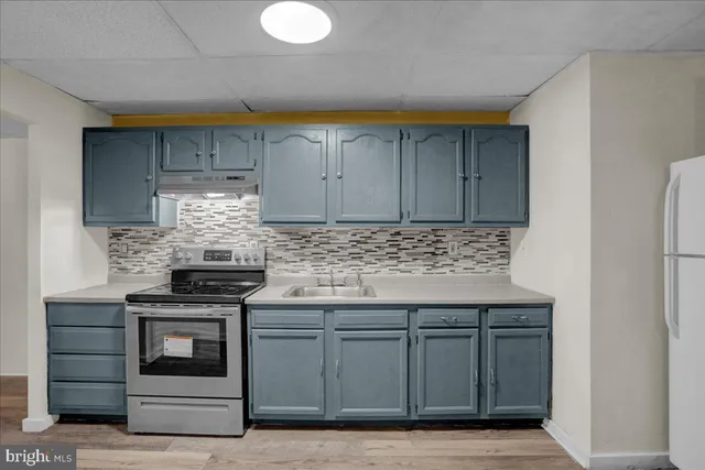 a kitchen with stainless steel appliances granite countertop a stove and a microwave