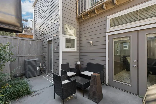 a backyard of a house with outdoor seating