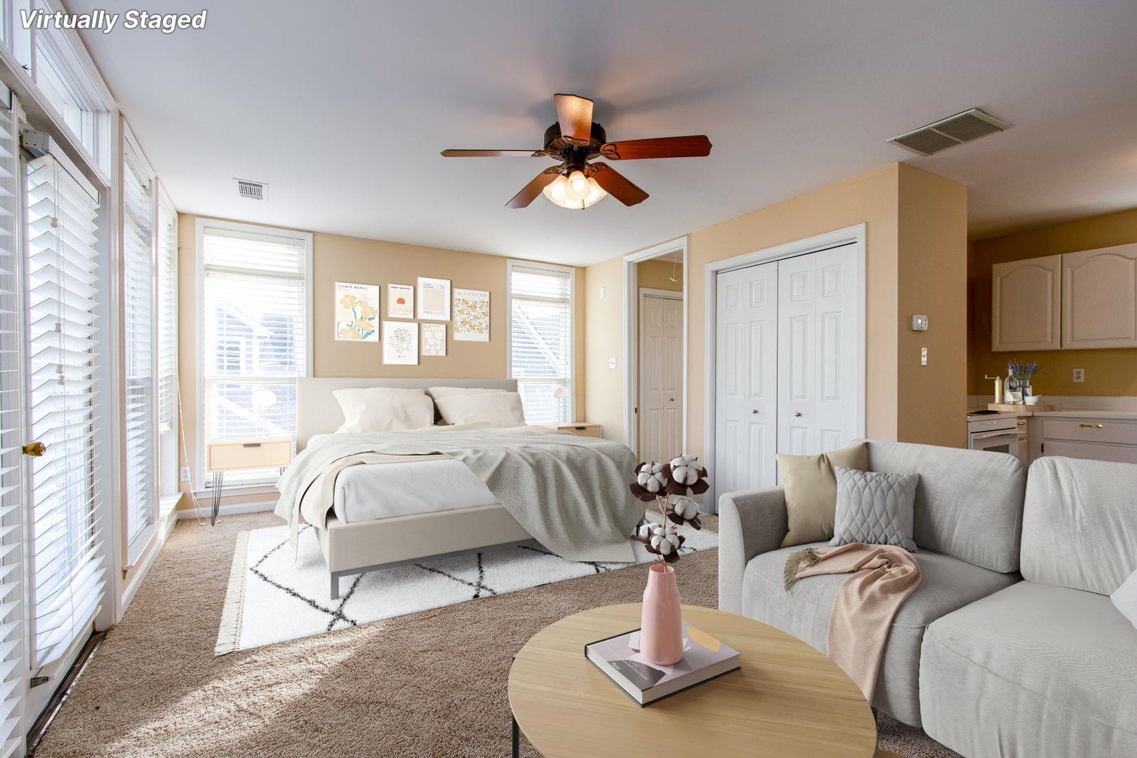 a living room with furniture a large window and a chandelier