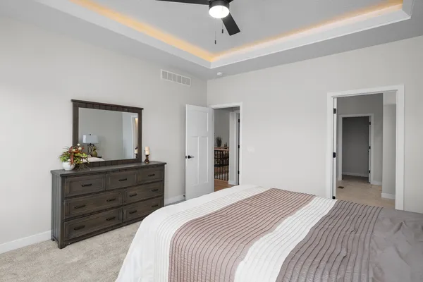 a bedroom with a bed and a dresser