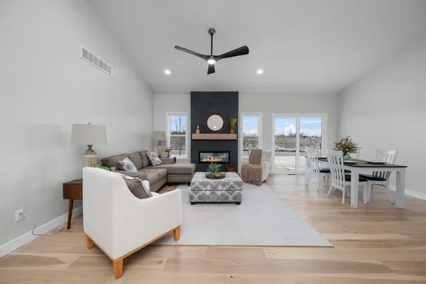 a living room with furniture and wooden floor