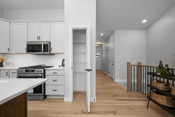 a kitchen with stainless steel appliances a stove refrigerator and cabinets
