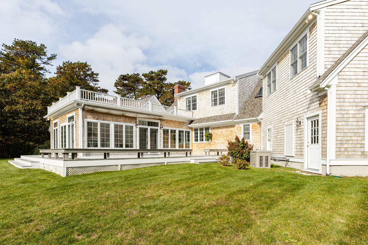 47 Farm Valley Road Osterville, MA 02655 - Photo 9 of 57 a front view of a building with a garden