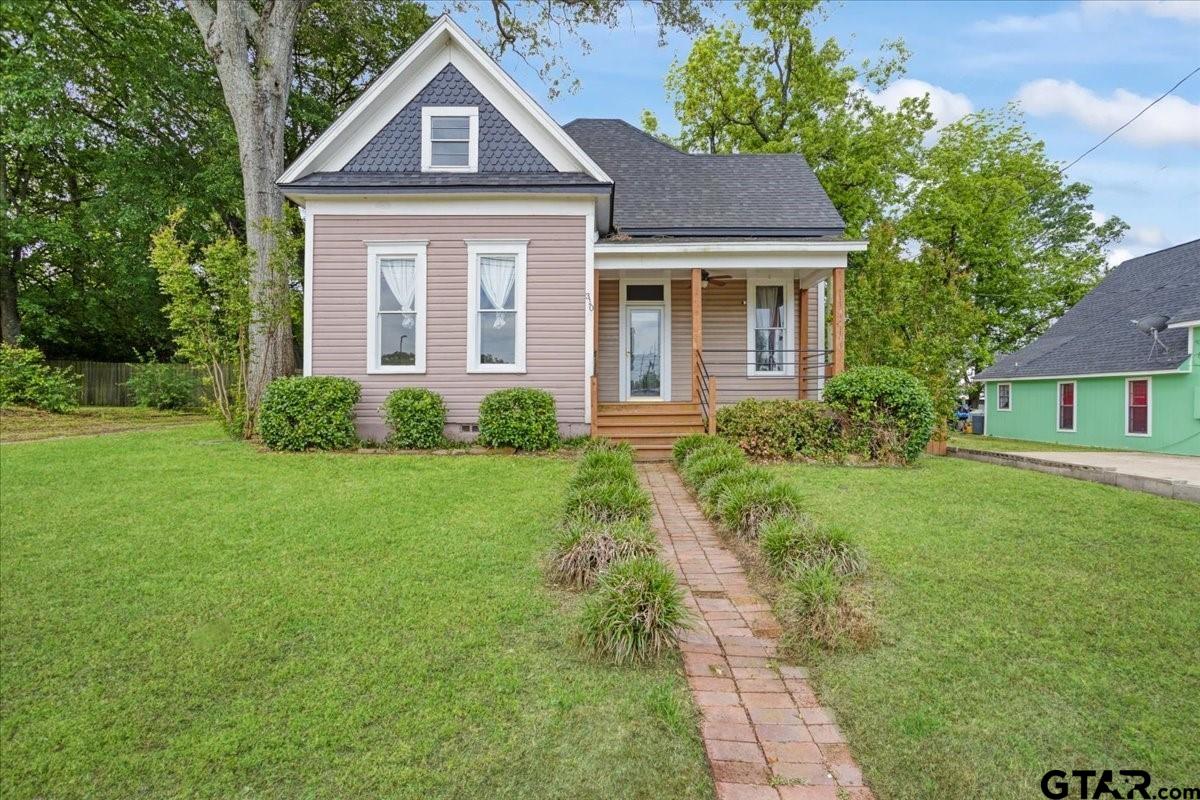 310 East 3rd Street Mount Pleasant, TX 75455 - Photo 1 of 35 a front view of a house with garden
