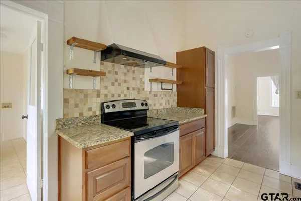 a kitchen with granite countertop cabinets and steel stainless steel appliances