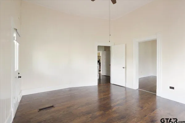 a view of an empty room with wooden floor