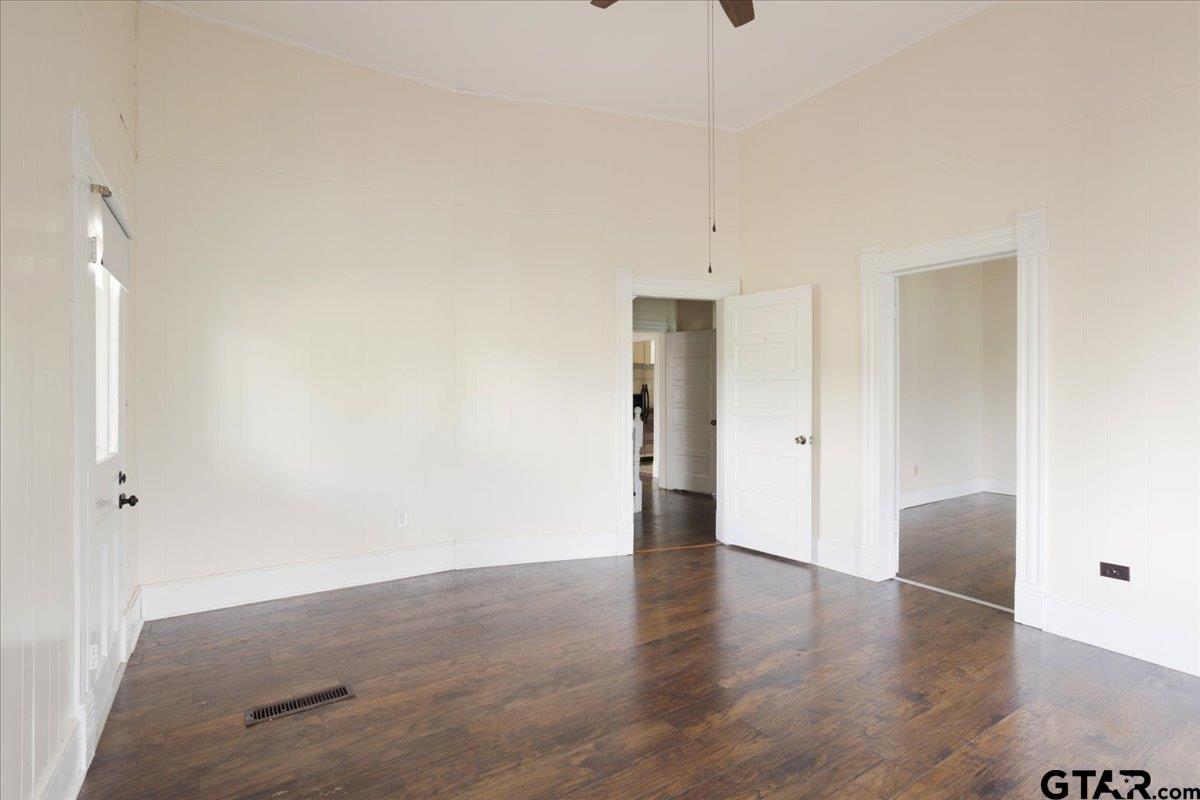 310 East 3rd Street Mount Pleasant, TX 75455 - Photo 15 of 35 a view of an empty room with wooden floor