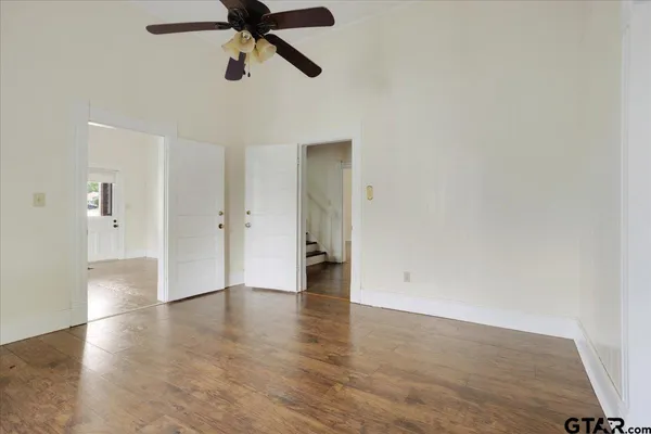 a view of an empty room and wooden floor