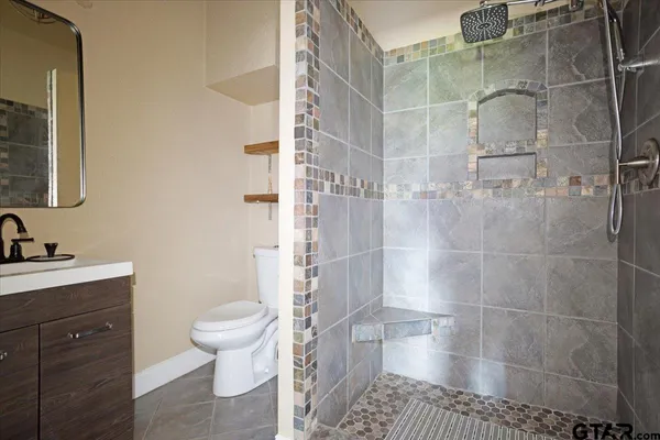 a bathroom with a sink toilet and shower