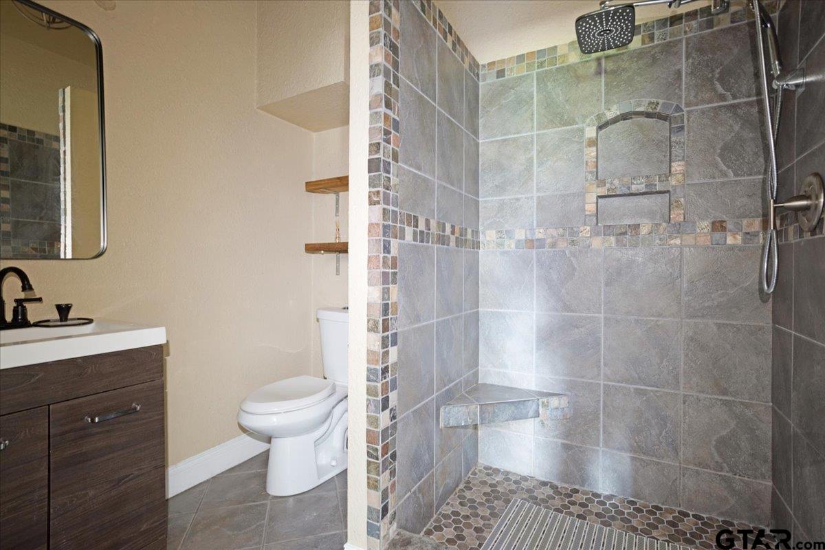 310 East 3rd Street Mount Pleasant, TX 75455 - Photo 18 of 35 a bathroom with a sink toilet and shower