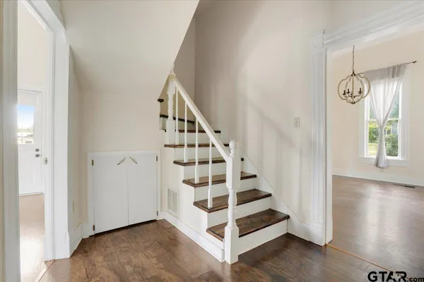 a view of entryway with wooden floor and stairs