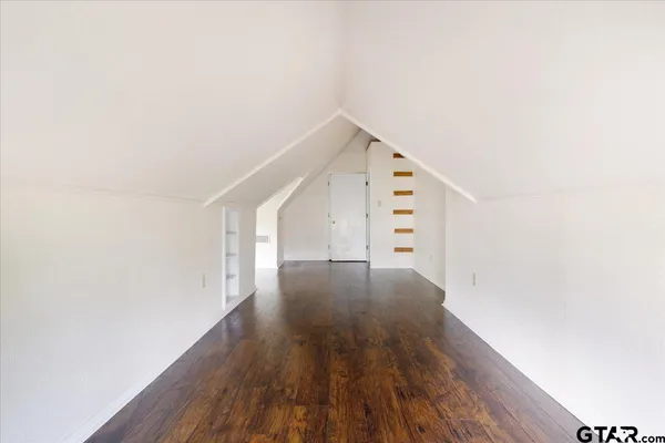 a view of a hallway with wooden floors