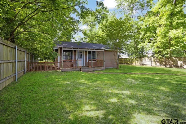 a view of a backyard with a garden and trees