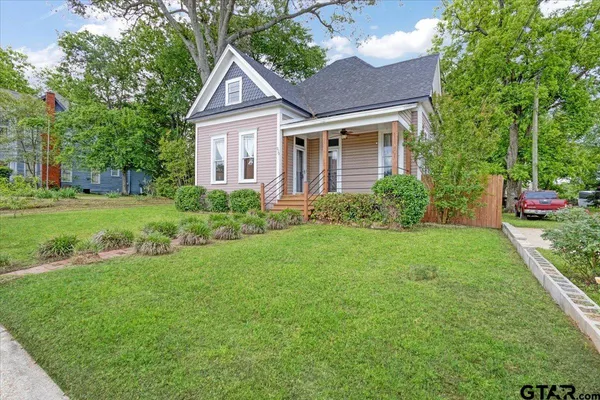 a front view of a house with garden