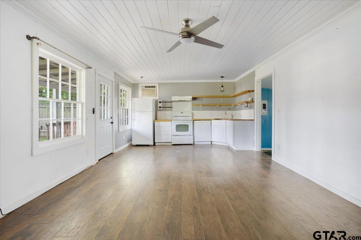 310 East 3rd Street Mount Pleasant, TX 75455 - Photo 31 of 35 a view of a big room with wooden floor a kitchen view and windows