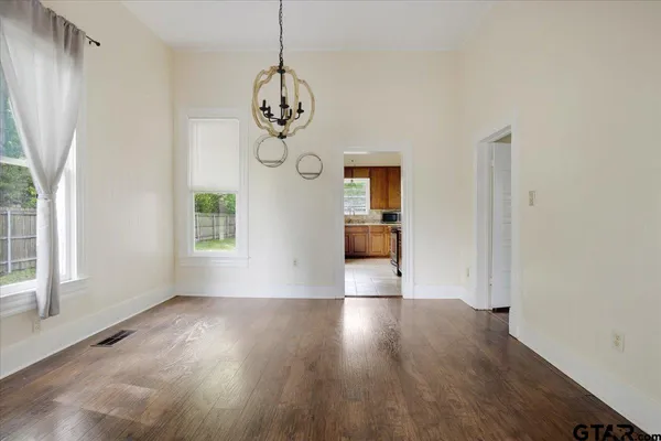 a view of a room with wooden floor and windows