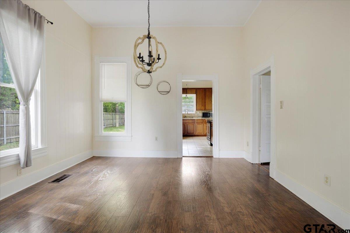 310 East 3rd Street Mount Pleasant, TX 75455 - Photo 8 of 35 a view of a room with wooden floor and windows