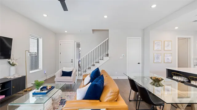 a living room with furniture and a wooden floor