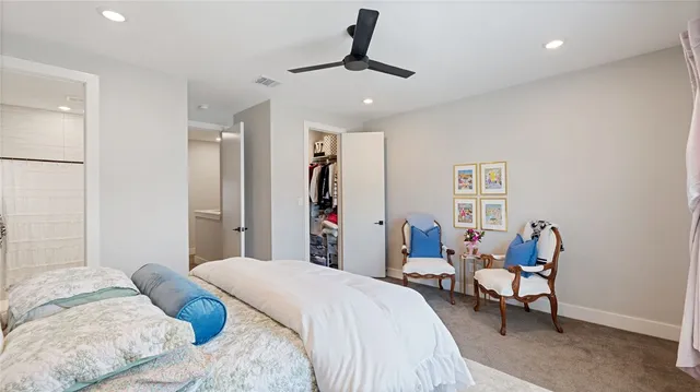 a bedroom with a bed couch and a window