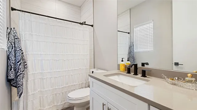 a bedroom with a bed a chair and a chandelier