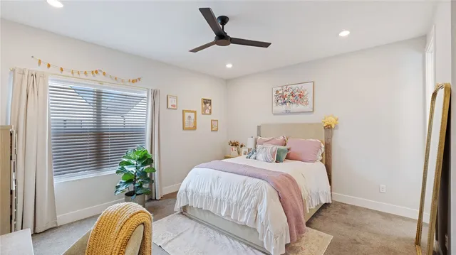 a bedroom with a bed a desk and chair