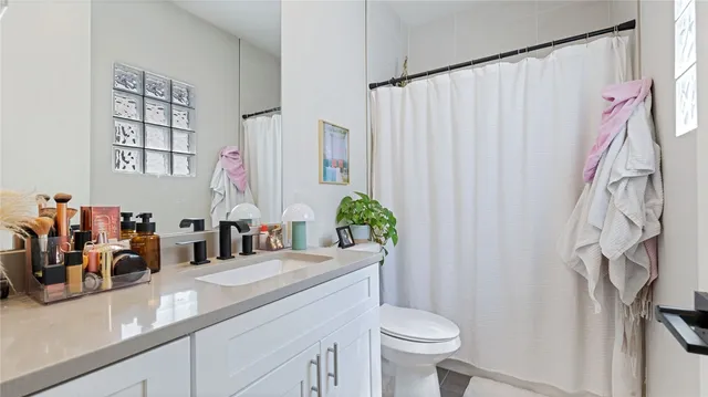 a bedroom with a bed and a potted plant
