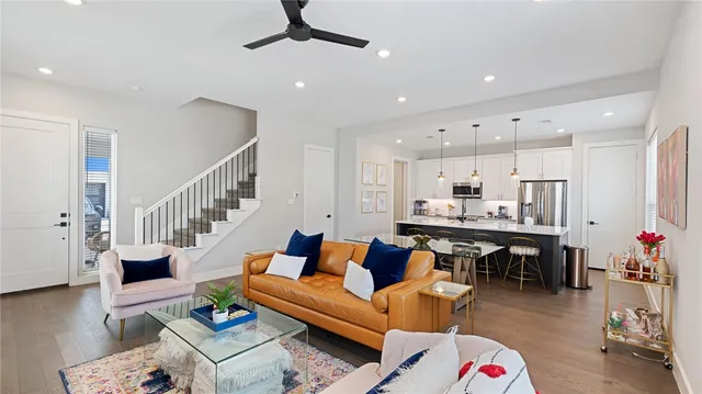 a living room with furniture kitchen view and a potted plant
