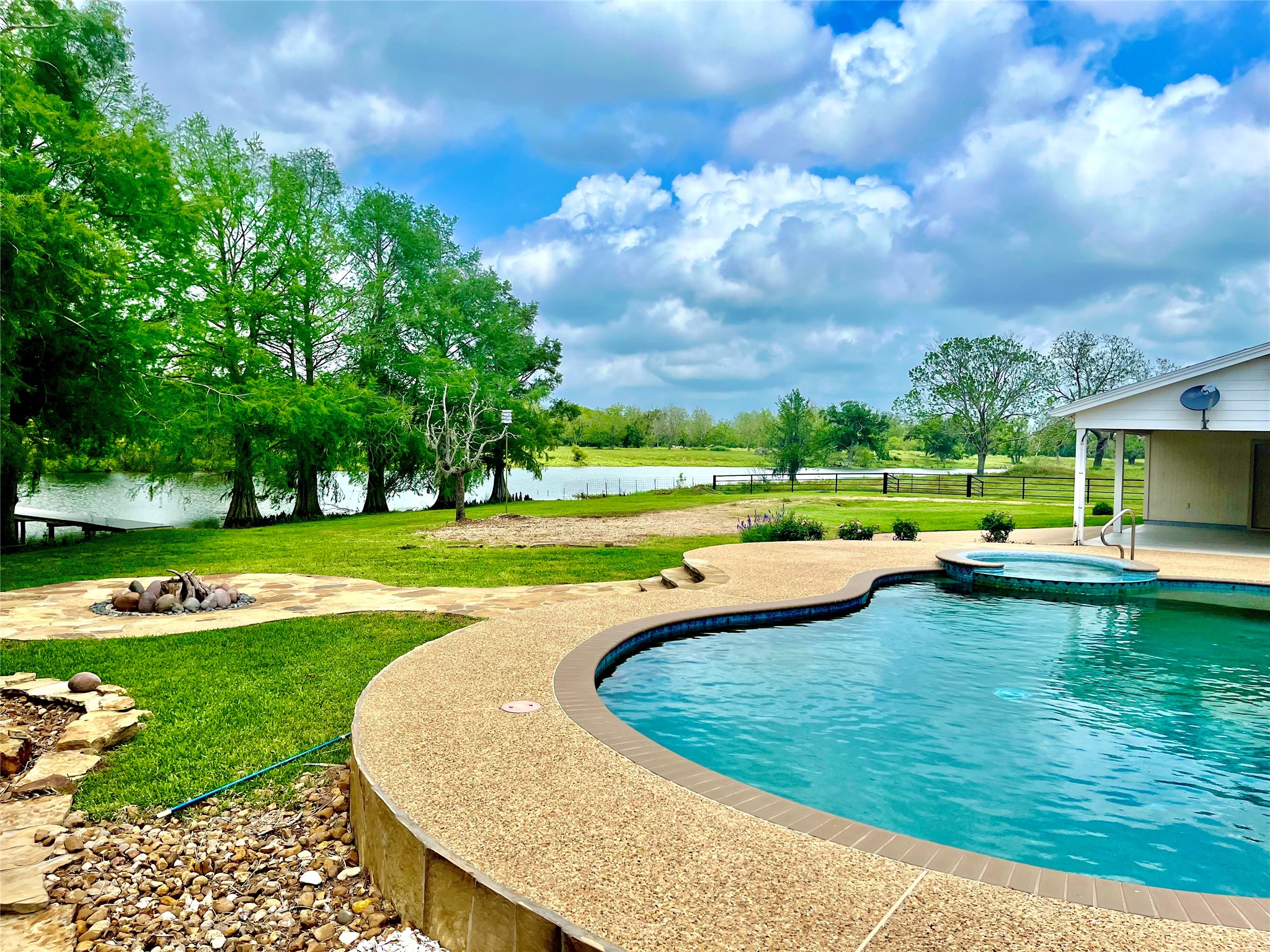 37243 FM 521 Road Bay City, TX 77414 - Photo 5 of 50 The swimming pool, spa and fire pit with large terrace sitting area provides a relaxing view of the lake.